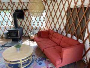 Living area with wood finished floors and a wood stove