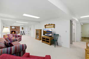 Living room featuring light carpet and a brick fireplace
