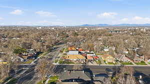 Aerial overview of property's location with nearby suburban area and a mountainous background