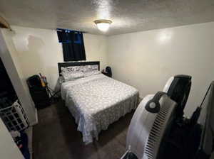 Bedroom featuring a textured ceiling