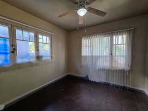 Unfurnished room featuring ceiling fan and plenty of natural light