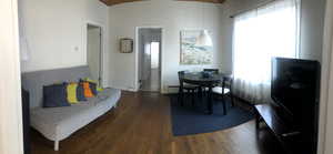 Dining space featuring dark wood-type flooring and arched walkways