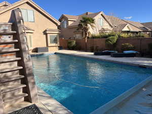 View of swimming pool with a fenced backyard and patio surround