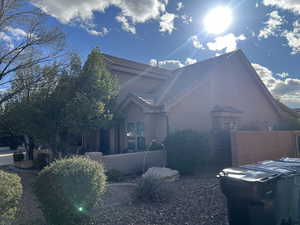 View of property exterior featuring stucco siding and a tile roof