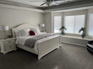 Bedroom featuring dark carpet and ceiling fan