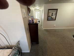 Hallway featuring carpet flooring and baseboards