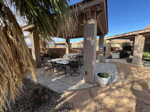 Fenced backyard with a patio and outdoor dining area