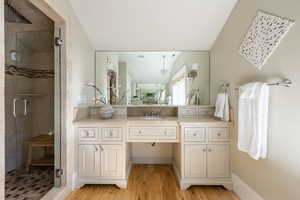 Full bath featuring vanity, a stall shower, and light wood-style flooring