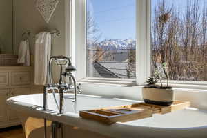 Bathroom view of a freestanding bath and a mountain backdrop