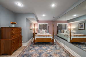 Bedroom with light wood finished floors and recessed lighting
