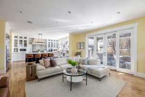Living room featuring light wood finished floors and recessed lighting
