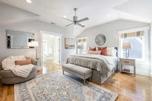 Bedroom with recessed lighting, light wood-style flooring, ensuite bath, vaulted ceiling, and a ceiling fan