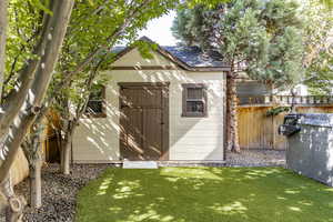 View of shed with a fenced backyard