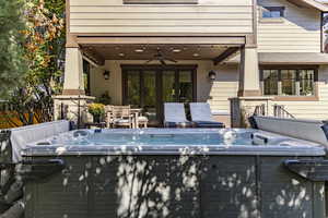View of pool featuring a hot tub and outdoor dining area