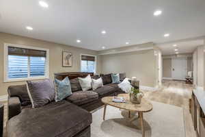 Living area featuring light wood-style floors and recessed lighting