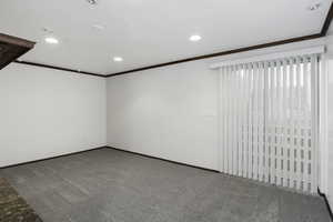 Carpeted empty room with ornamental molding and recessed lighting