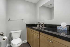 Bathroom featuring vanity and toilet