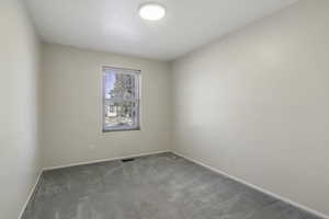 Unfurnished room featuring light colored carpet and baseboards