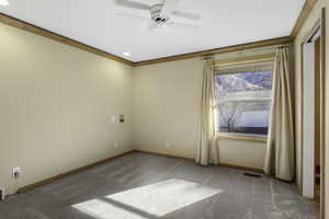Empty room featuring ceiling fan, light colored carpet, recessed lighting, and crown molding