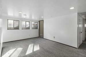 Empty room with light carpet and baseboards