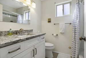 Bathroom with vanity and shower / tub combo with curtain