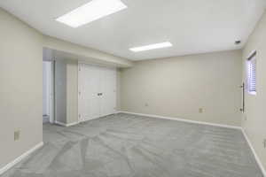 Unfurnished bedroom with light carpet and a closet