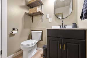 Half bathroom with vanity and light wood-style floors
