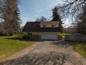 View of front of house featuring driveway and an attached garage