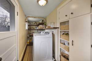 Laundry area with separate washer and dryer and baseboards