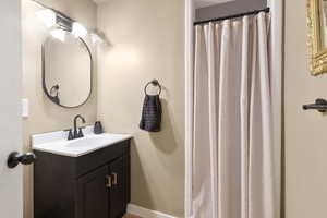 Bathroom featuring vanity and a stall shower