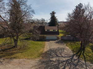 View of front of home featuring dirt driveway