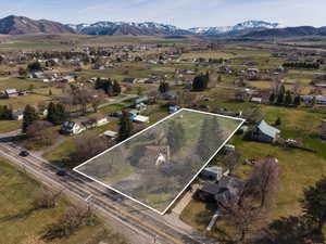 Aerial view of residential area with a mountain backdrop and property boundaries highlighted