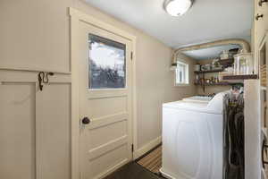 Laundry area with baseboards and washing machine and dryer