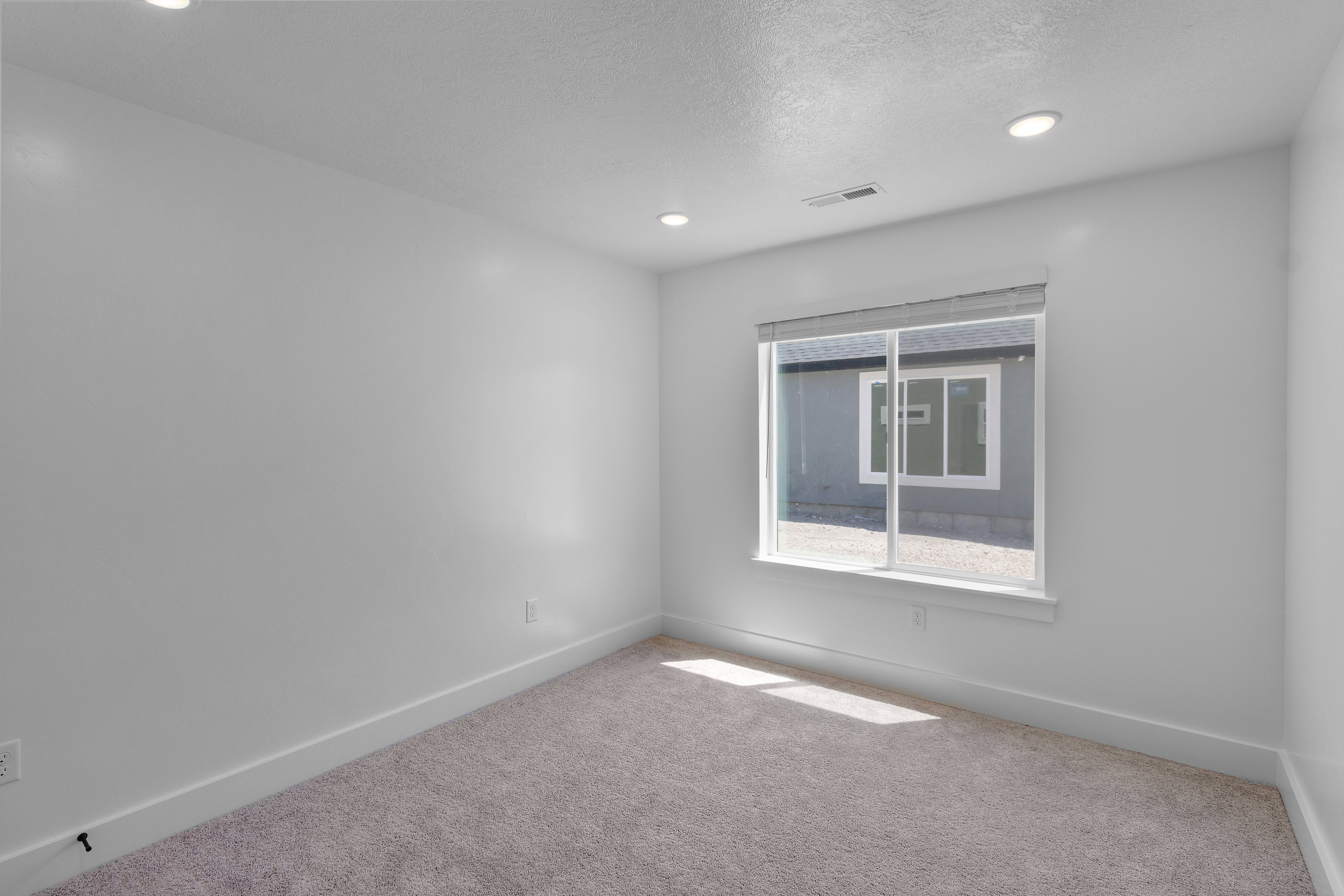 Unfurnished room featuring carpet flooring, recessed lighting, and a textured ceiling