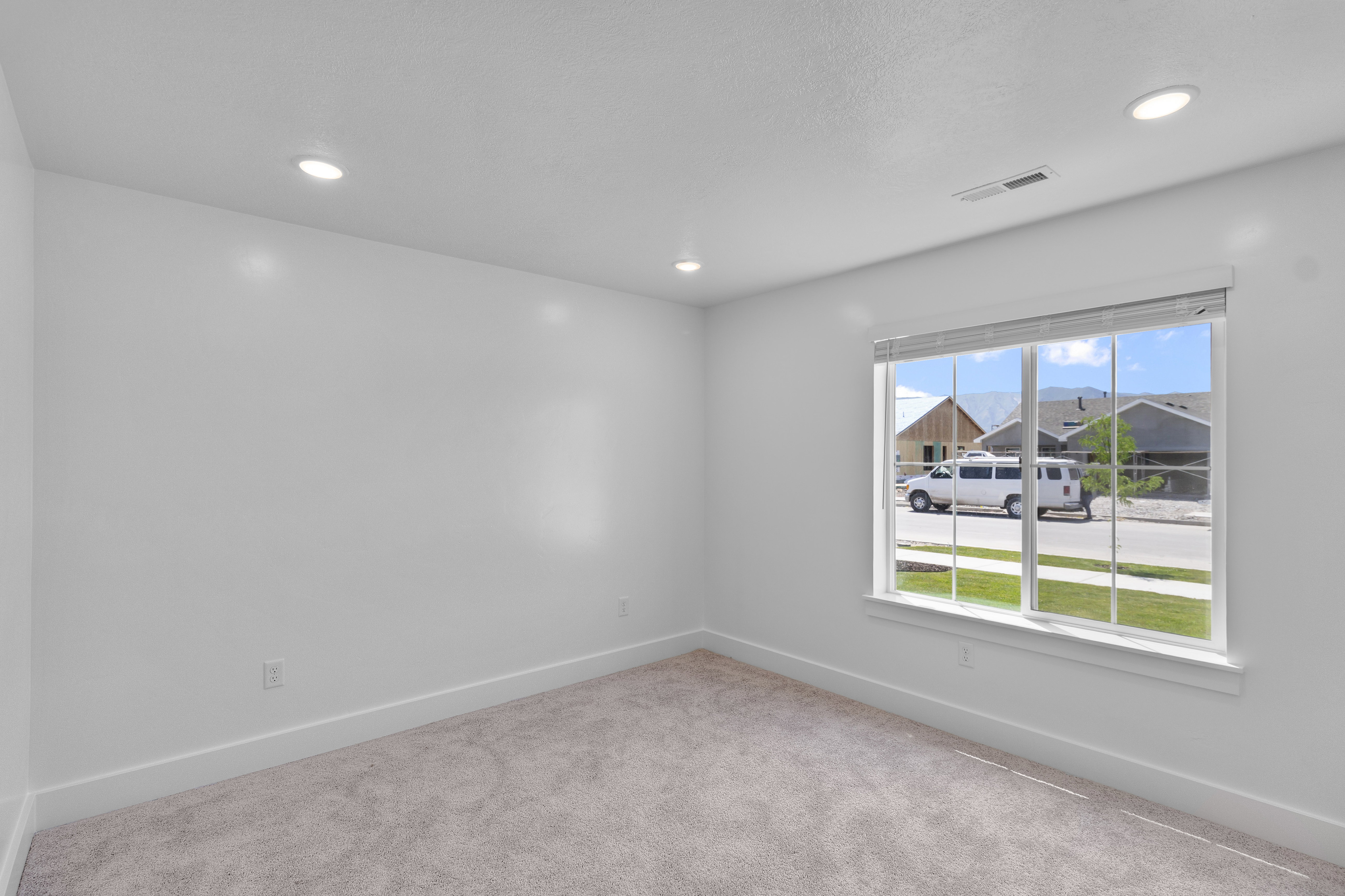 Empty room with carpet and recessed lighting