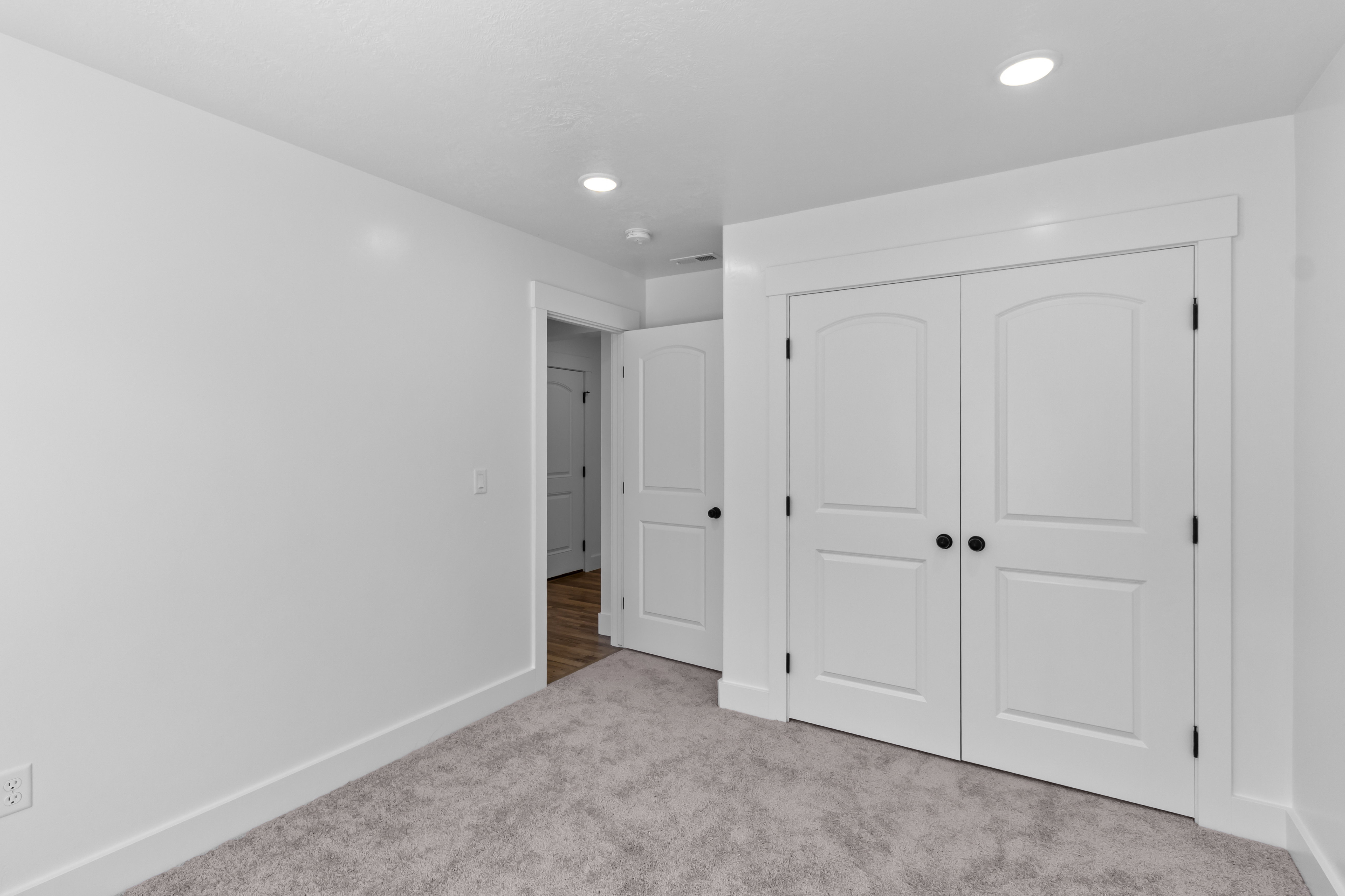 Unfurnished bedroom featuring a closet, carpet floors, and recessed lighting