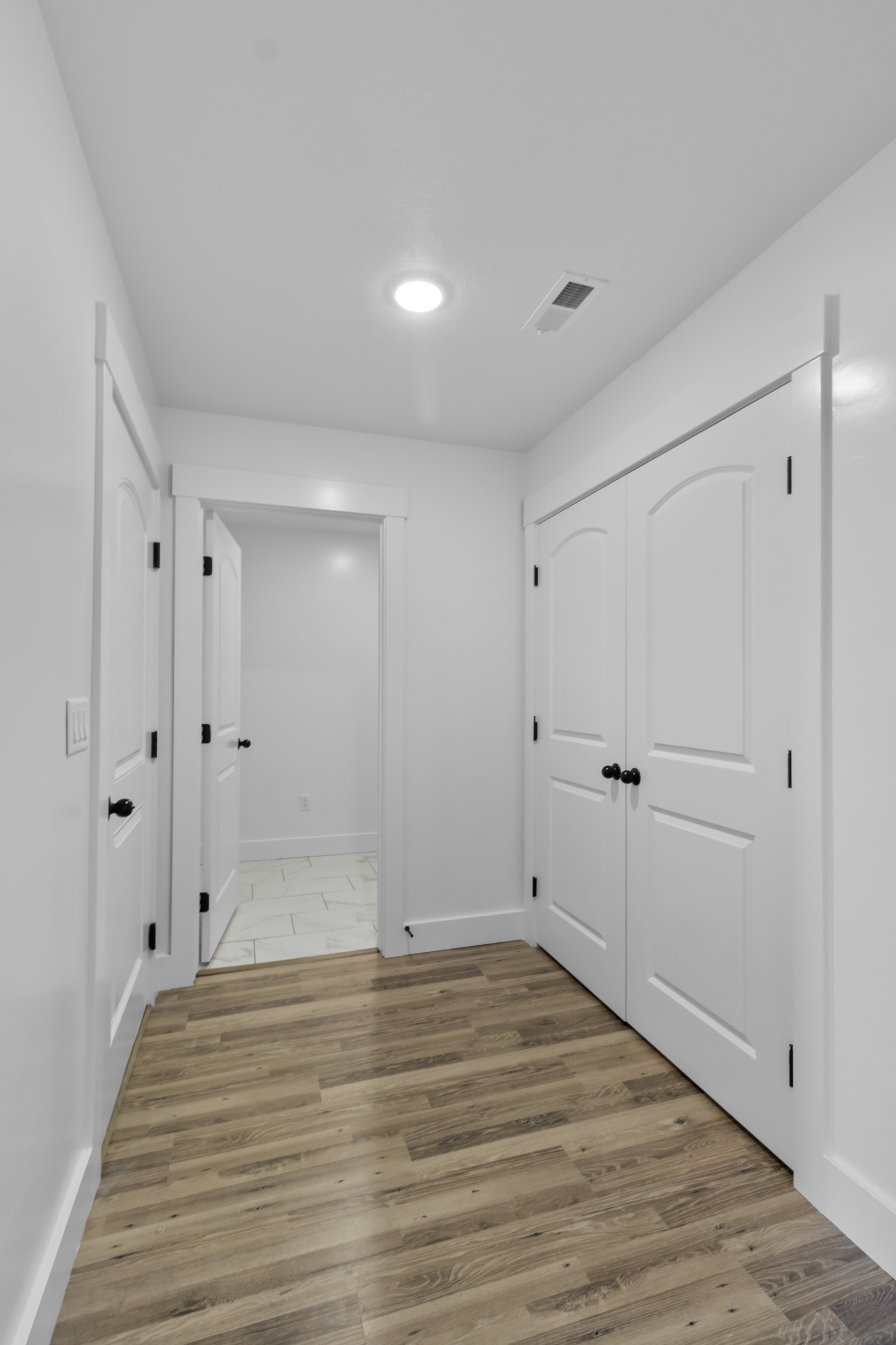 Hall with light wood-style flooring and baseboards