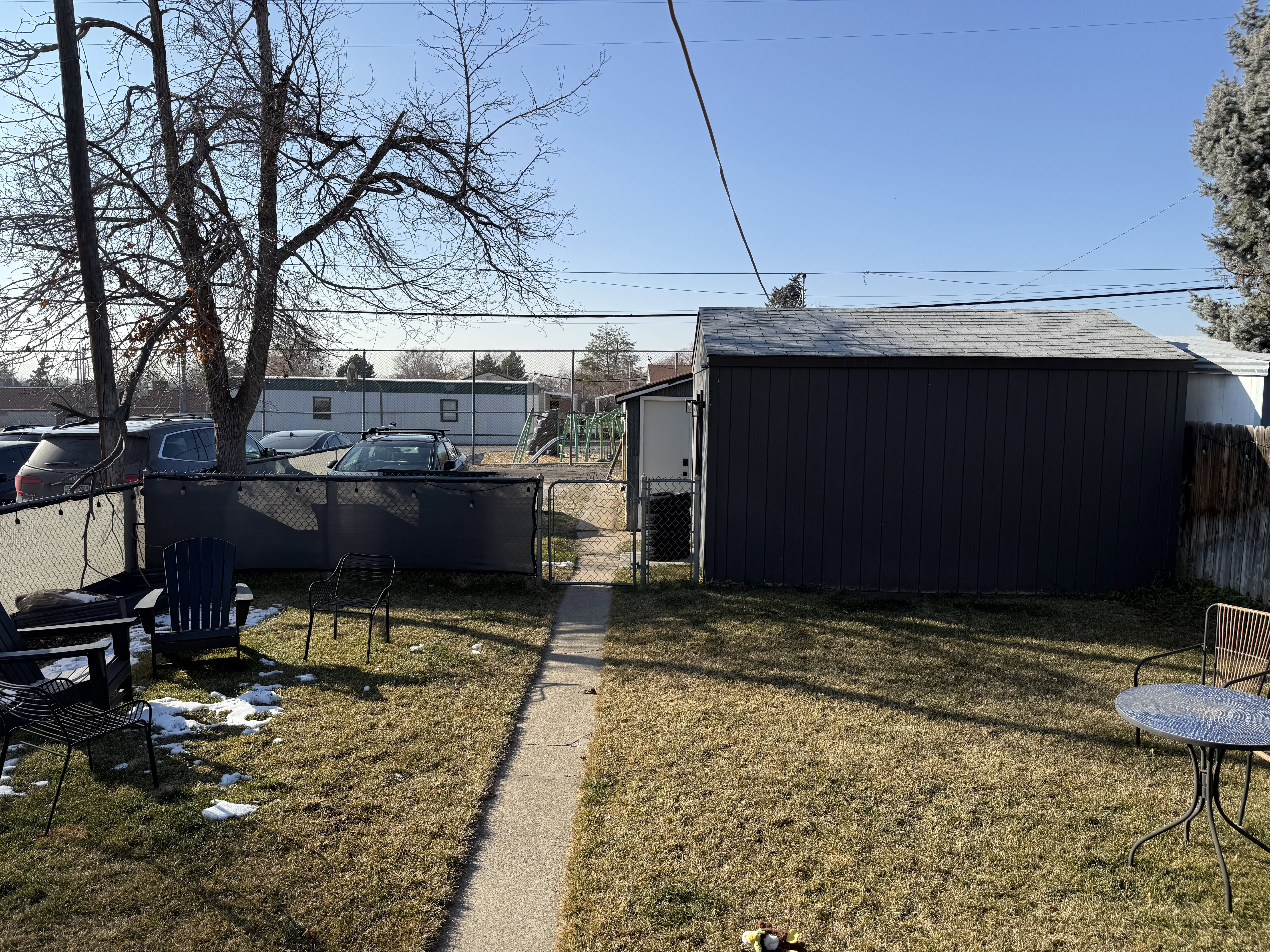View of yard with a gate and an outbuilding