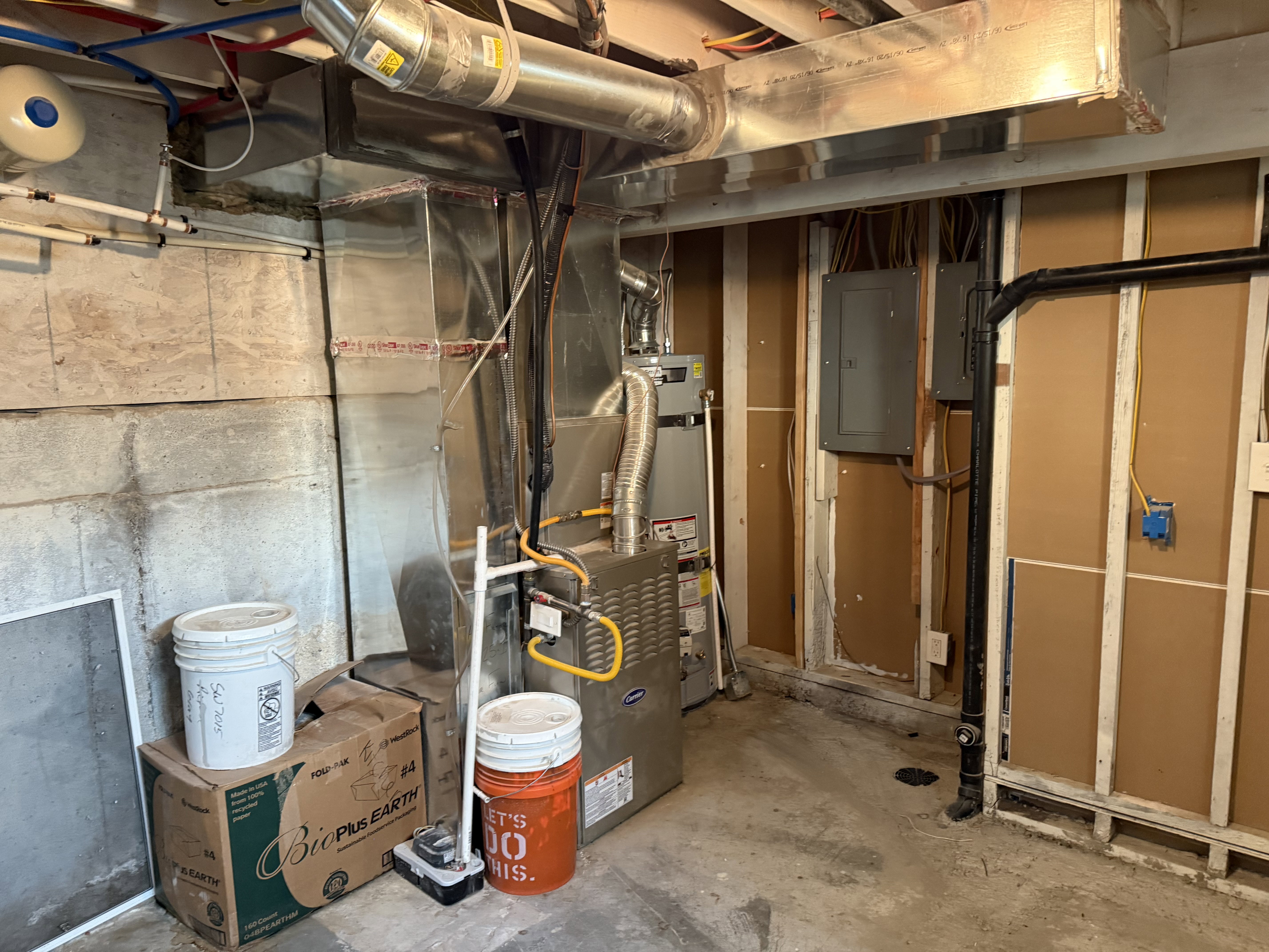 Utilities featuring electric panel and strapped water heater