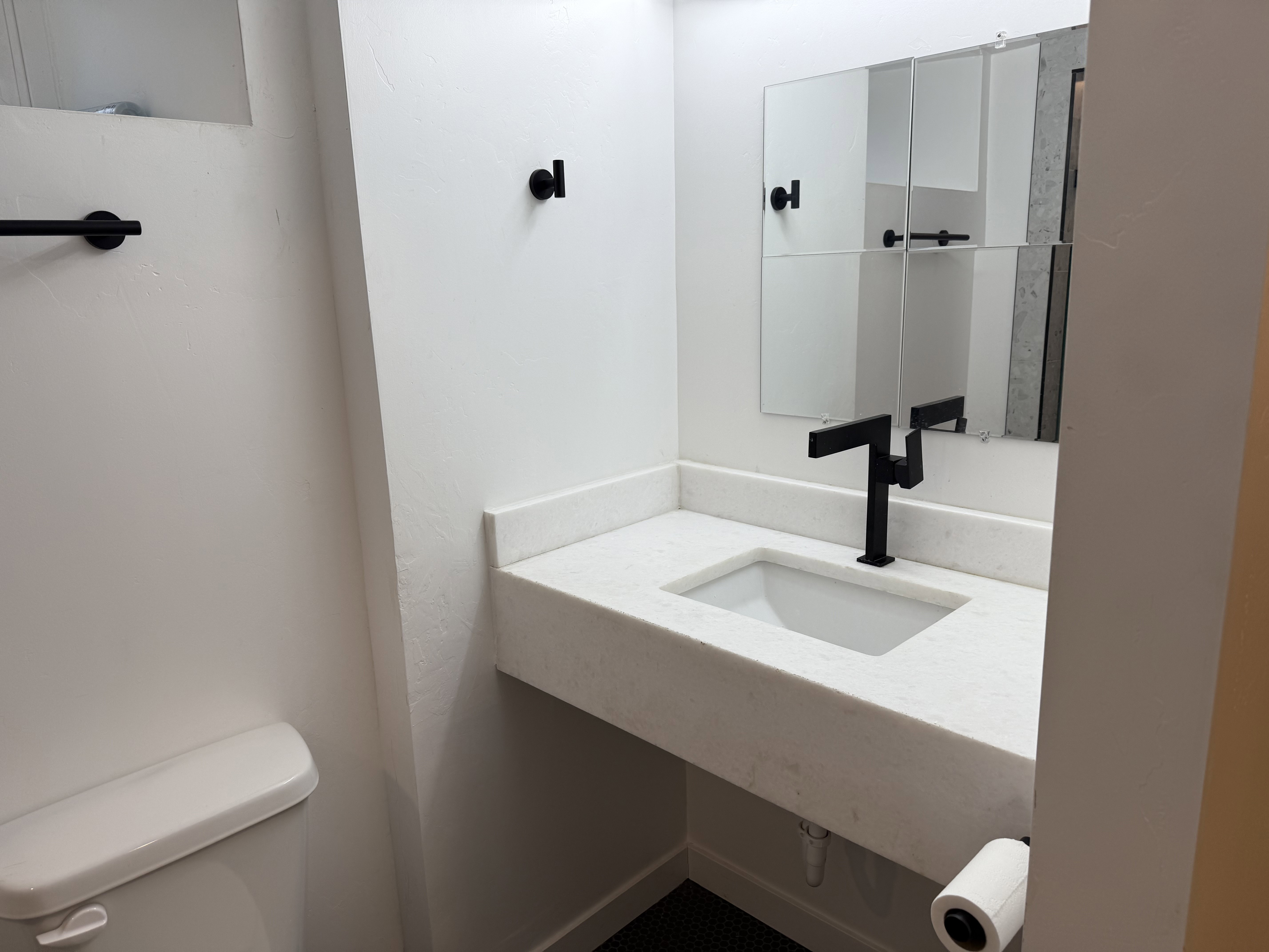 Half bath featuring toilet and vanity