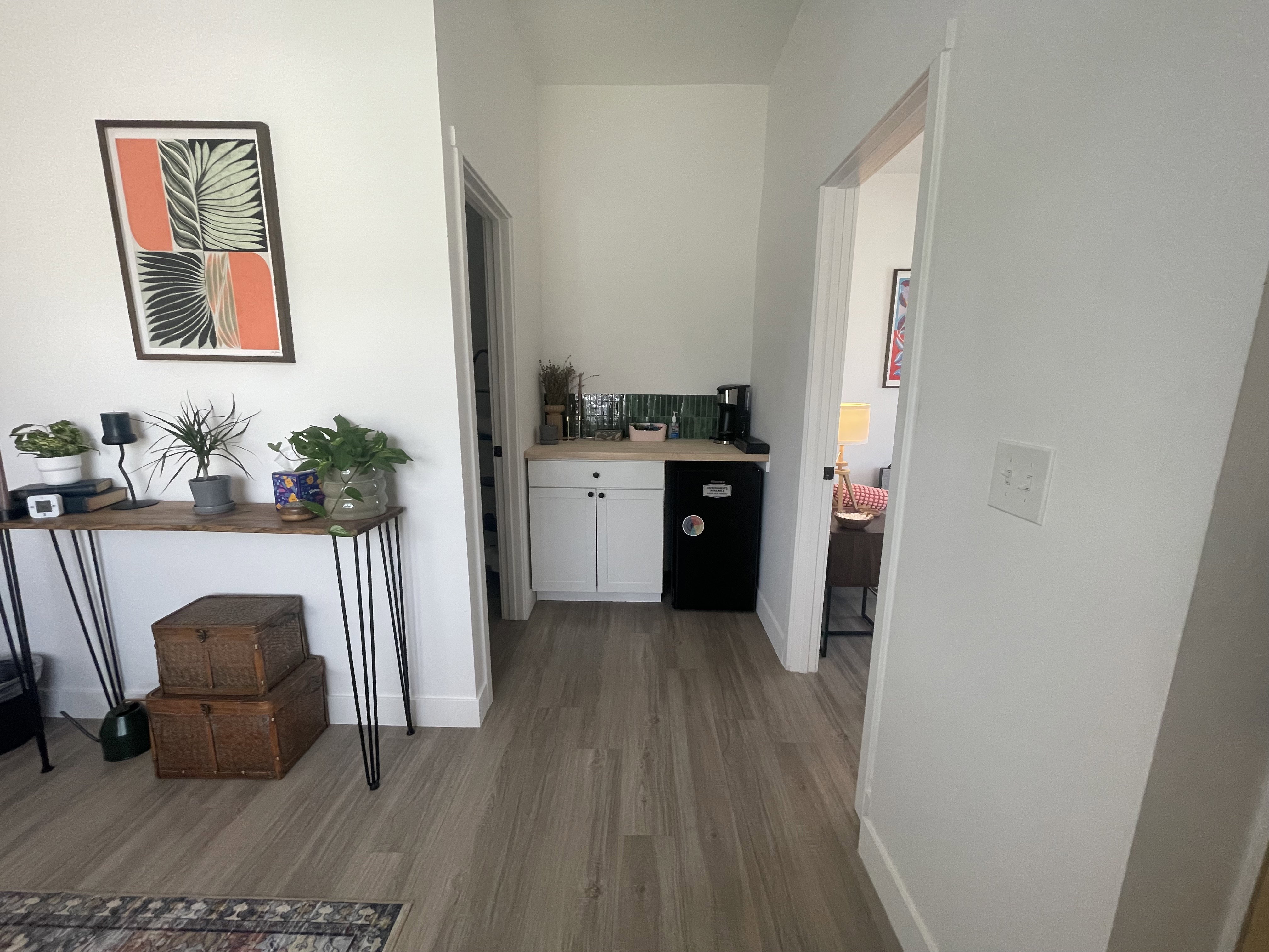 Hall featuring dark wood-type flooring and baseboards