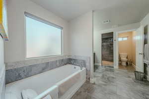 Bathroom with a garden tub and walk in shower