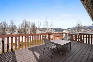 Wooden terrace with a residential view and outdoor dining area