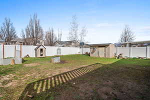 Fenced backyard with a storage unit