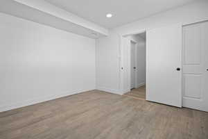 Unfurnished bedroom with light wood finished floors and recessed lighting