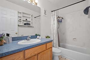 Full bathroom featuring vanity and shower / bath combo with shower curtain