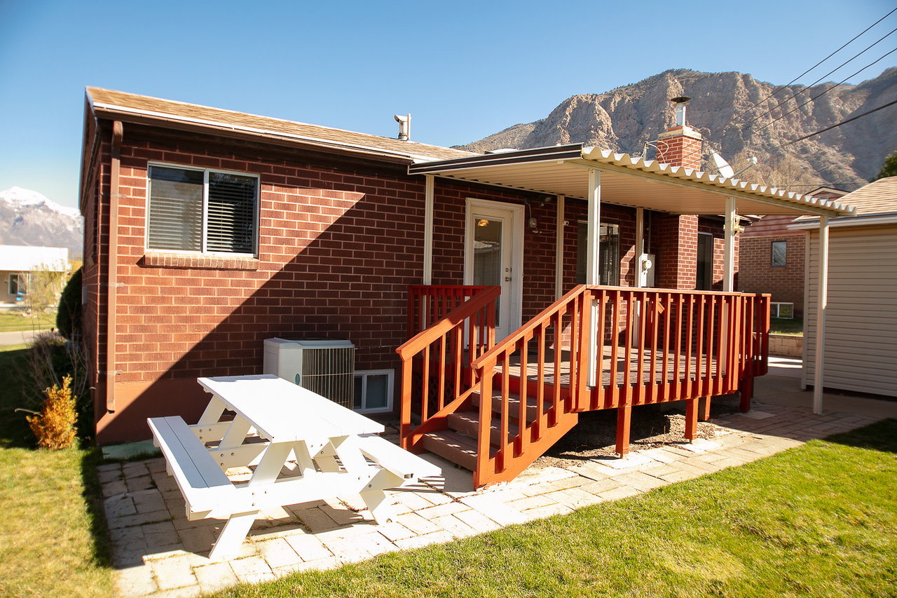 Back of the house showing the covered deck and outdoor patior