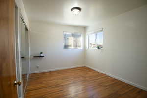 Bedroom 1 with hardwood floors and lots of natural light