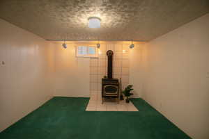 Other half of the basement family room with wood burning stove