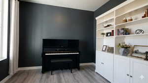 Living area featuring light wood finished floors and a textured ceiling